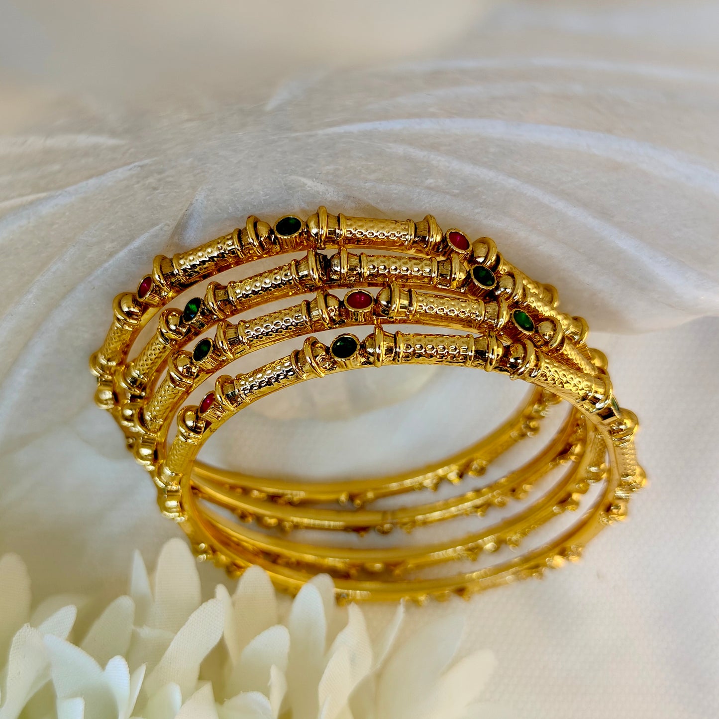 Set of four (non-openable) bangles with Ruby green Kundan work